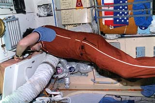 Mir-18 commander Vladimir N. Dezhurov performing in-flight maintenance in the Core module of the Mir space station. 